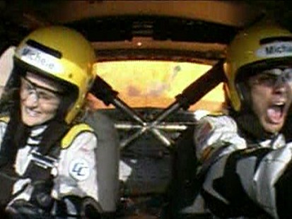 VIDEO: A show lets driving enthusiasts race on a track with a passenger barking at them.