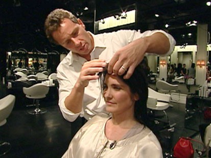A picture of Chris Cuomo cutting someones hair.