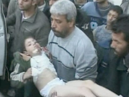 VIDEO: A man carrying an injured boy.
