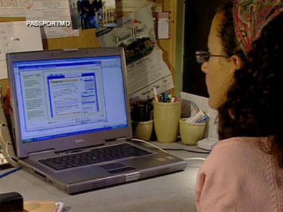 A picture of a woman using a computer.