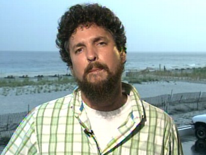 VIDEO: Reporter Ben Raines captured as many as 28 sharks swimming in shallow water.