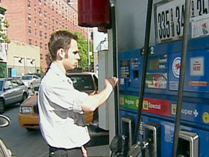 A picture of a man paying for gas.