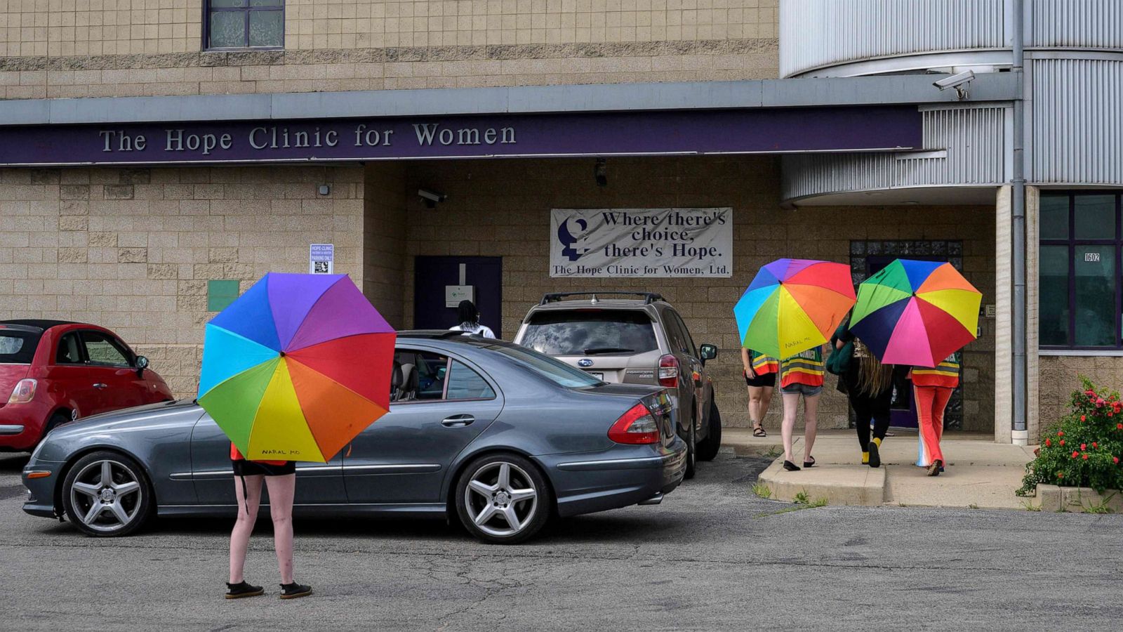 PHOTO: In this June 25, 2022, file photo, volunteer clinic escorts shield a patient from anti-abortion activists outside the Hope Clinic For Women in Granite City, Illinois.