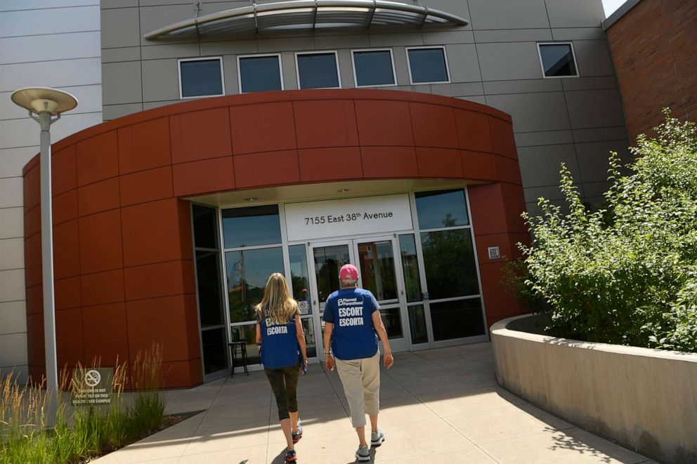 PHOTO: In this July 18, 2019, file photo, volunteer escorts wait to assist incoming patients outside of the Planned Parenthood in Denver, Colorado.