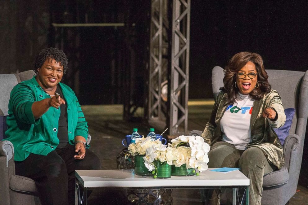 PHOTO: Oprah Winfrey and Georgia gubernatorial candidate Stacey Abrams greet a crowd gathered for a town hall conversation at the Cobb Civic Center's Jennie T. Anderson Theatre in Marietta, Ga., Nov. 1, 2018.