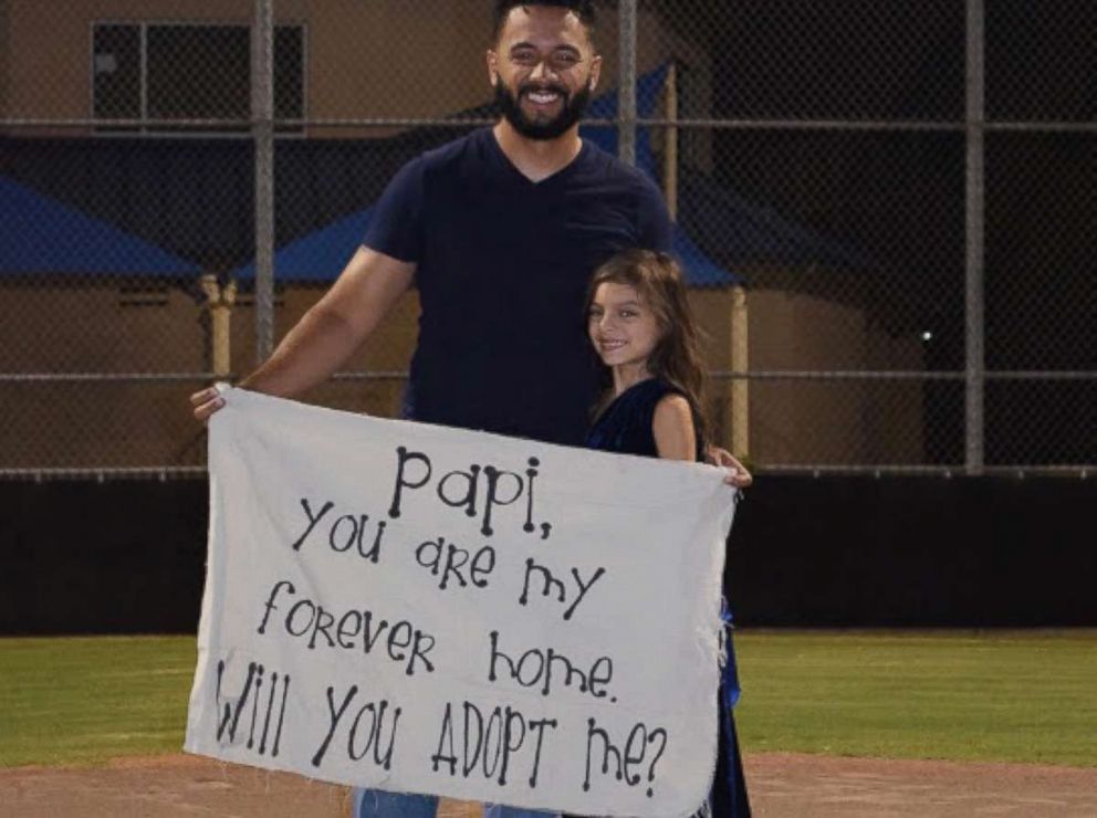 PHOTO: Leonardo Avila stood on a pitcher's mound at a baseball field in Alabaster, Alabama on Sept. 21. When he opened his eyes, his stepdaughter Alessandra was holding a sign asking him to make her his own.