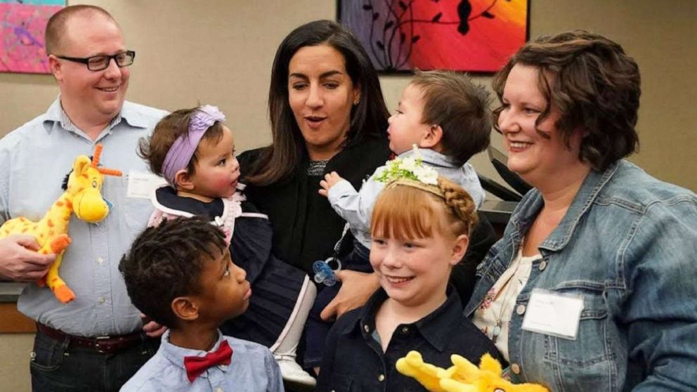 PHOTO: The Hall family poses with Judge Shereen Askalani for a photo after adopting 15-month-old twins Charlotte and Titus on Nov. 23, 2019, in Minn.