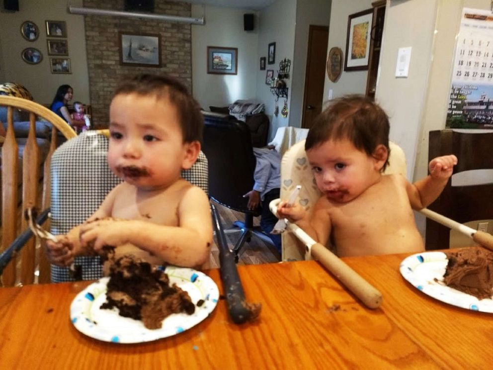 PHOTO: A photo shows twin siblings Titus and Charlotte, 15 months old, eating pieces of cake celebrating their adoption on Nov. 23, 2019, in Minn.
