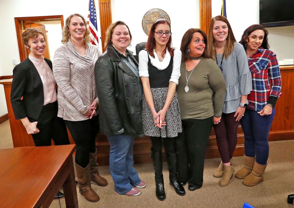 PHOTO: Scarlet poses with some of the many people who helped her get adopted, on her adoption day at the Grant County Courthouse in Marion, Ind., Nov. 16, 2018.