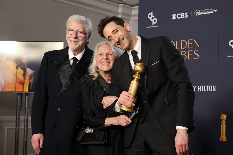 PHOTO: Elliott Brody, Sylvia Plachy, and Adrien Brody pose in the press room during the 82nd Annual Golden Globe Award at The Beverly Hilton on January 05, 2025 in Beverly Hills, California.