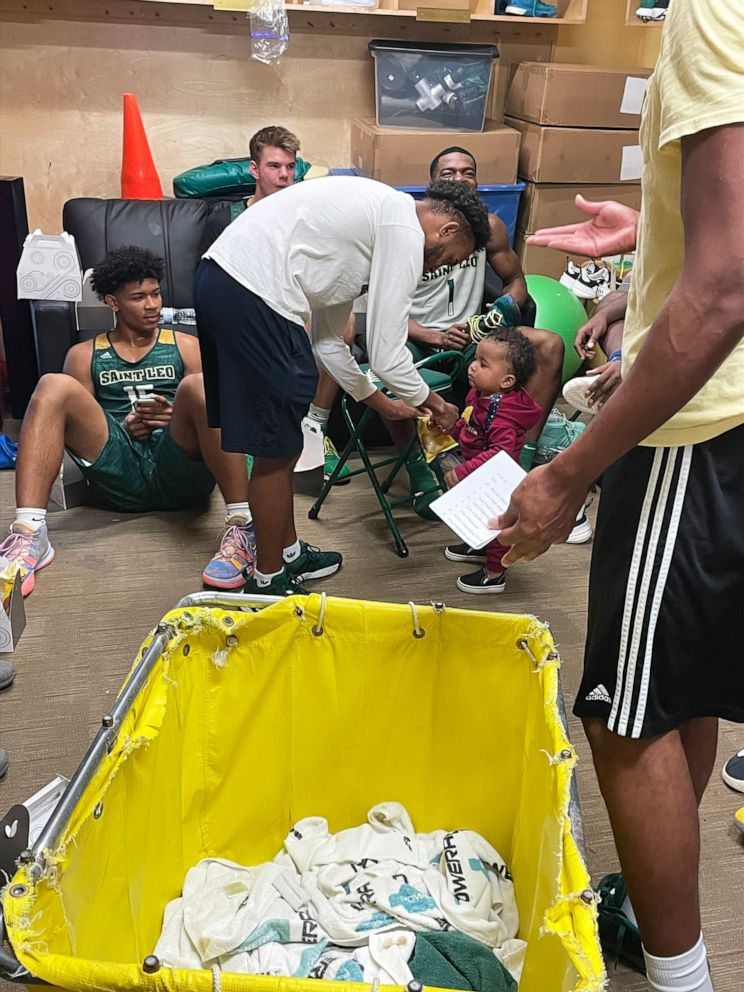 PHOTO: Aiden Webster, the son of Saint Leo University assistant basketball coach Ashley Webster, is pictured alongside the university's men's basketball team.