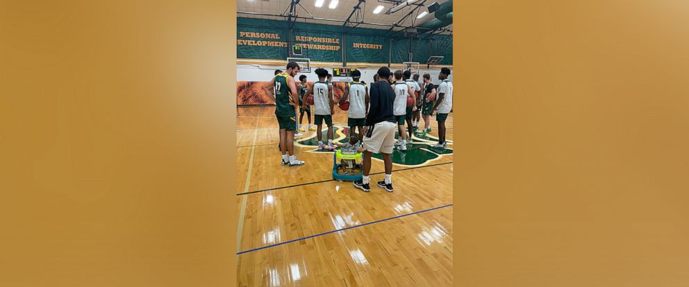 PHOTO: Aiden Webster, the son of Saint Leo University assistant basketball coach Ashley Webster, is pictured alongside the university's men's basketball team.