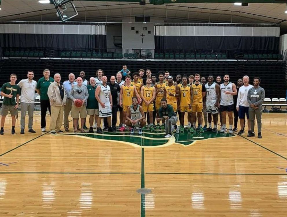 PHOTO: Aiden Webster, the son of Saint Leo University assistant basketball coach Ashley Webster, is pictured alongside the university's men's basketball team.