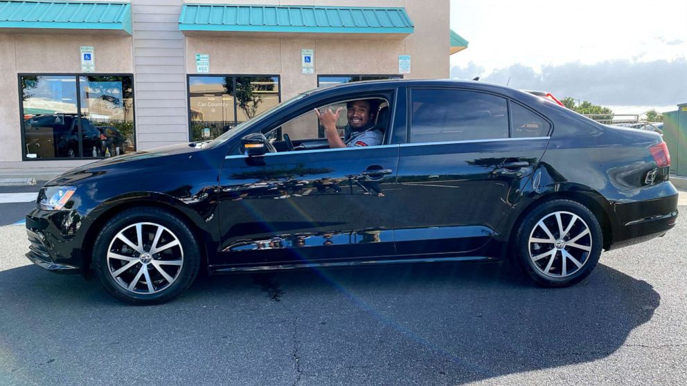 Aina Townsend, 22, of Maui, Hawaii, pictured in his Volkswagen Jetta, which was gifted to him by the Maui community after he returned a wallet to its owner.
