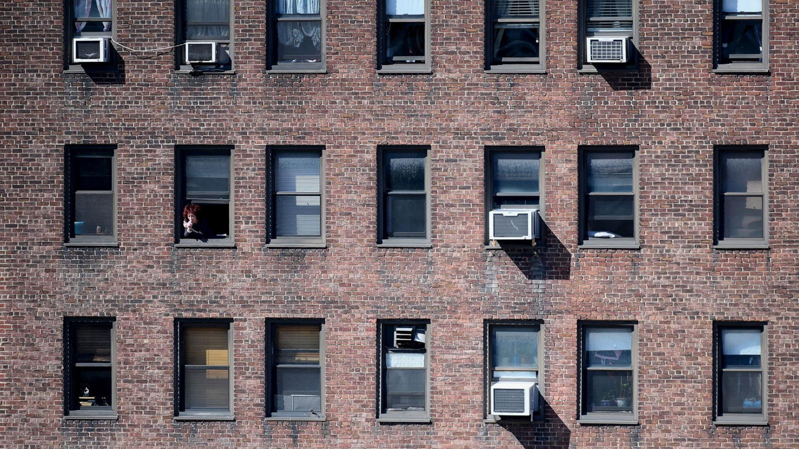 PHOTO: In this March 24, 2020, file photo, a person looks out of their window in New York.
