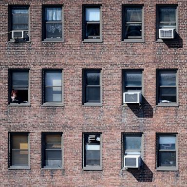 [PHOTO: In this March 24, 2020, file photo, a person looks out of their window in New York.]