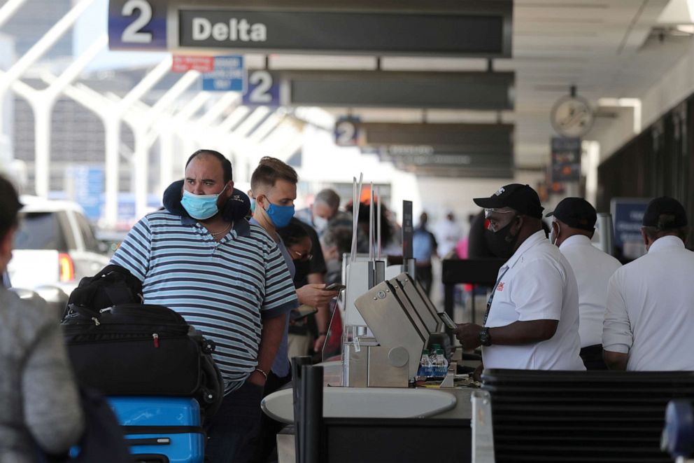 PHOTO: Passengers queue at LAX airport before Memorial Day weekend, as the coronavirus (COVID-19) disease continues, in Los Angeles, May 27, 2021.