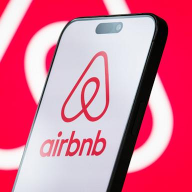 PHOTO: The logo of Airbnb, Inc. is displayed on a smartphone screen, with the company's branding visible in the background.