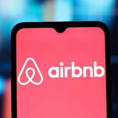 PHOTO: The Airbnb logo is seen displayed on a smartphone screen in a photo illustration. 