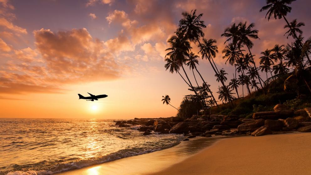 PHOTO: Stock photo of a plane flying over an island.