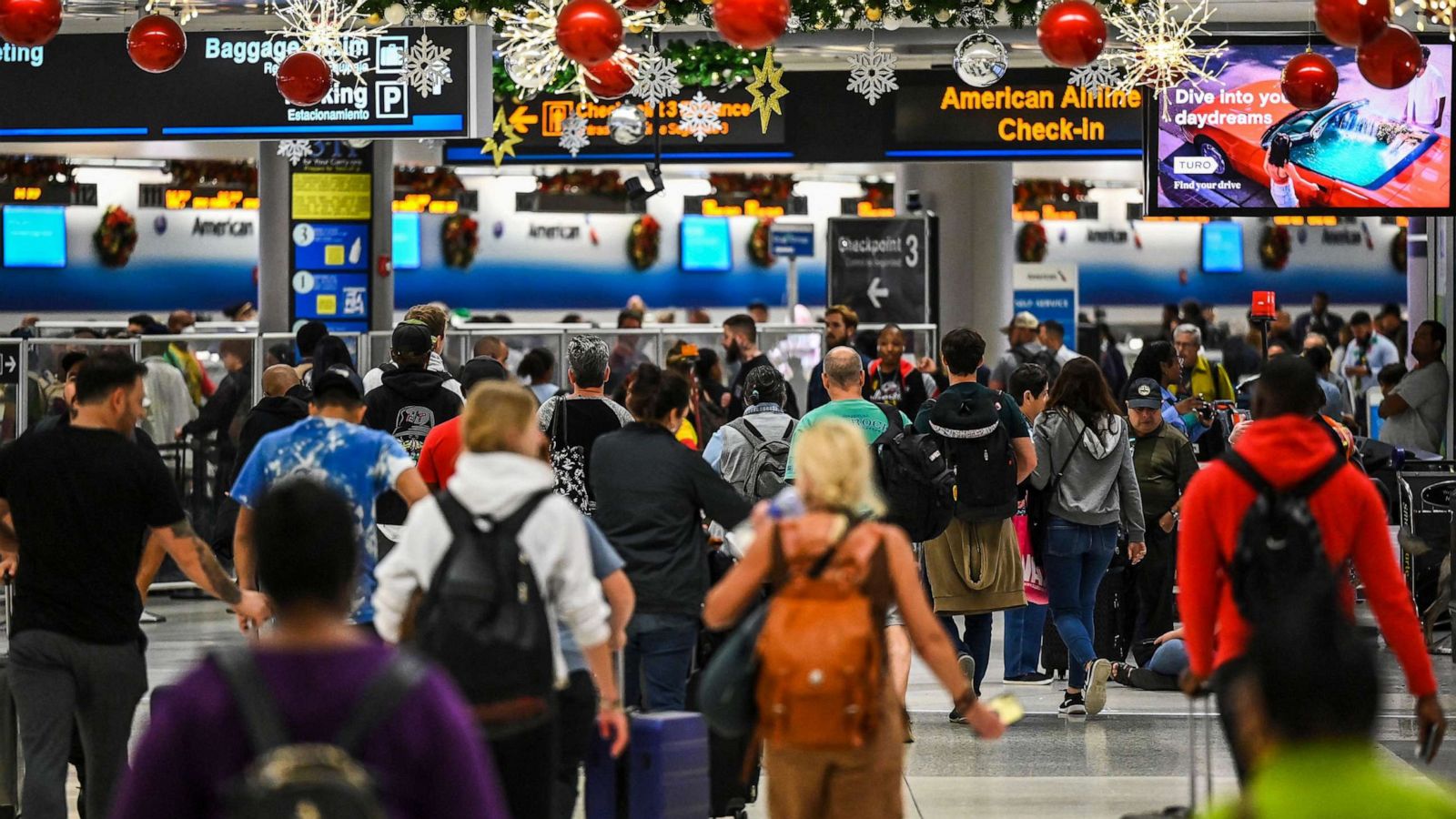 PHOTO: Travelers walk through Miami International Airport during a winter storm ahead of the Christmas holiday, Dec. 23, 2022, in Miami.