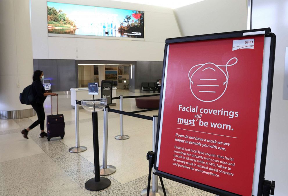 PHOTO: A sign stating that masks are required at San Francisco International Airport stands in a terminal after the federal mask mandate for airports and pubic transportation was lifted, April 19, 2022, in San Francisco.