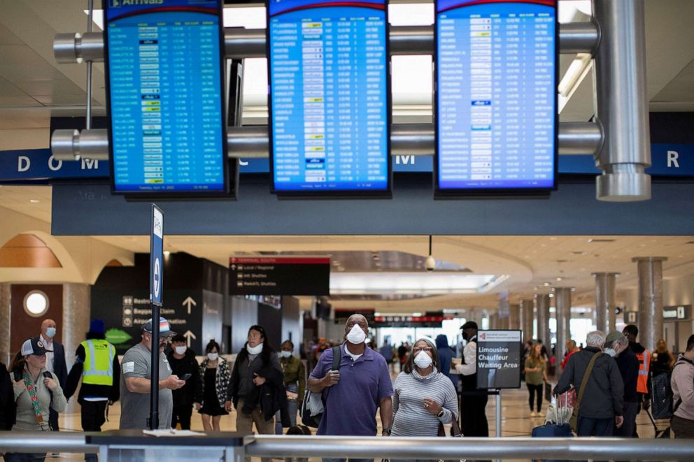 PHOTO: People wearing masks navigate through the domestic terminal of the Hartsfield-Jackson Atlanta International Airport in Atlanta, April 19, 2022. 