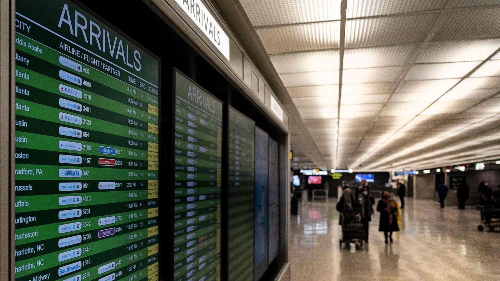 PHOTO: Travelers exit the International Arrivals area at Dulles International Airport in Dulles, Va., Nov. 29, 2021.