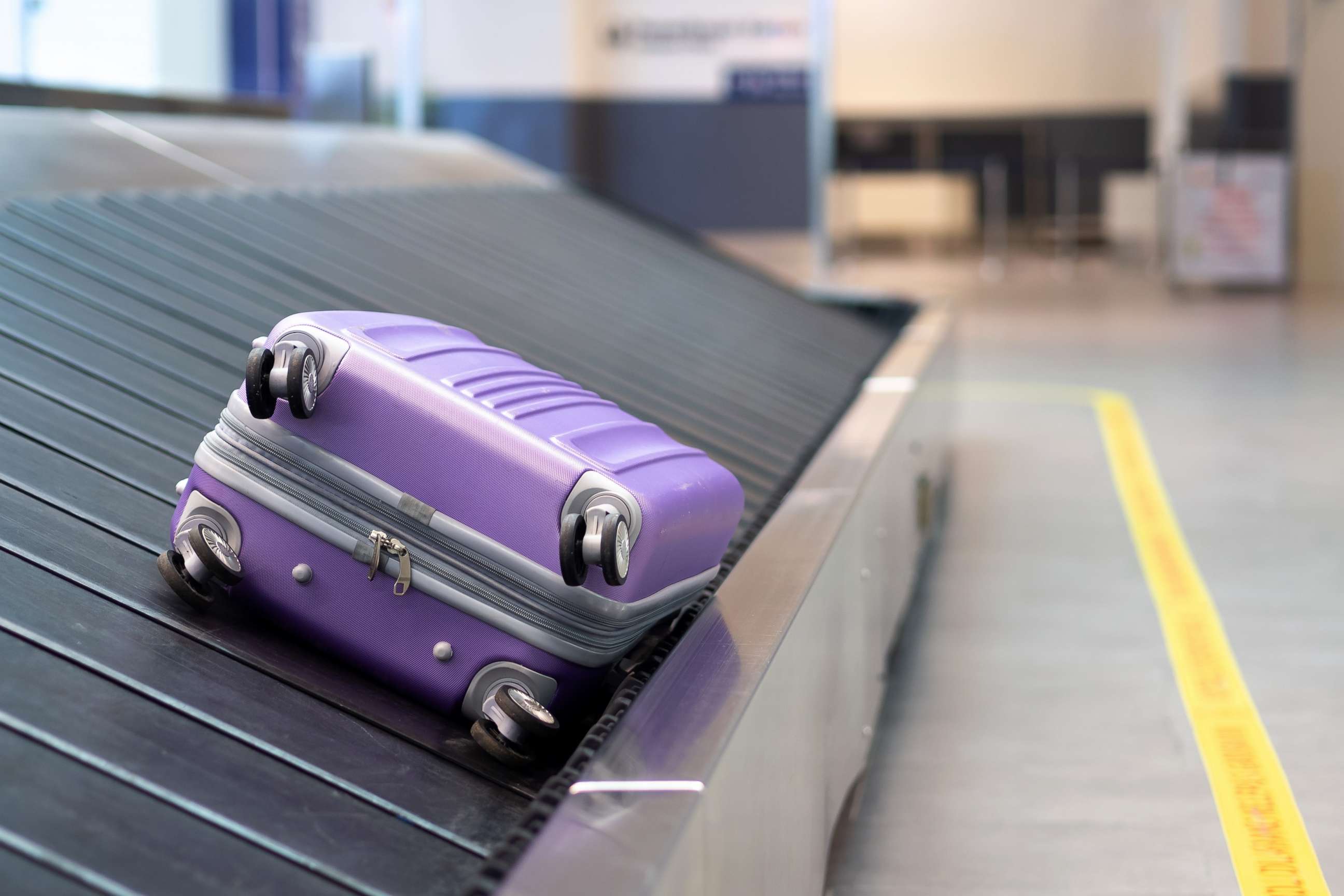 PHOTO: A suitcase rides a baggage claim conveyor belt in this stock photo.
