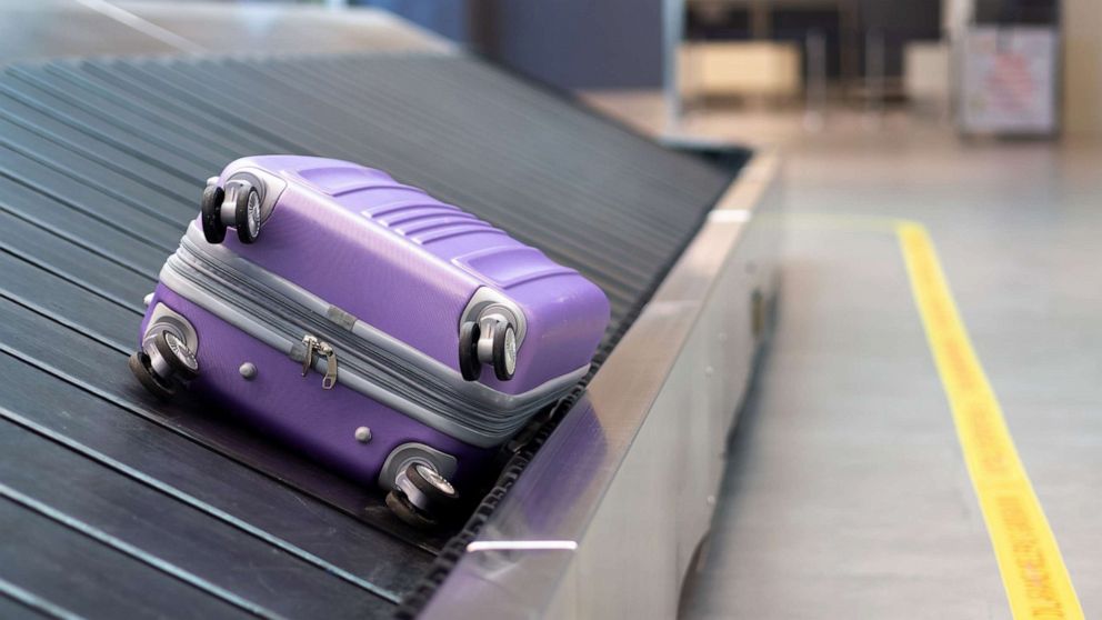 PHOTO: A suitcase rides a baggage claim conveyor belt in this stock photo.