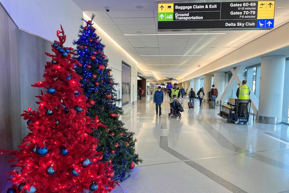 PHOTO: In this Nov. 22, 2022, file photo, passengers walk through the Delta terminal at LaGuardia Airport in Queens, New York.