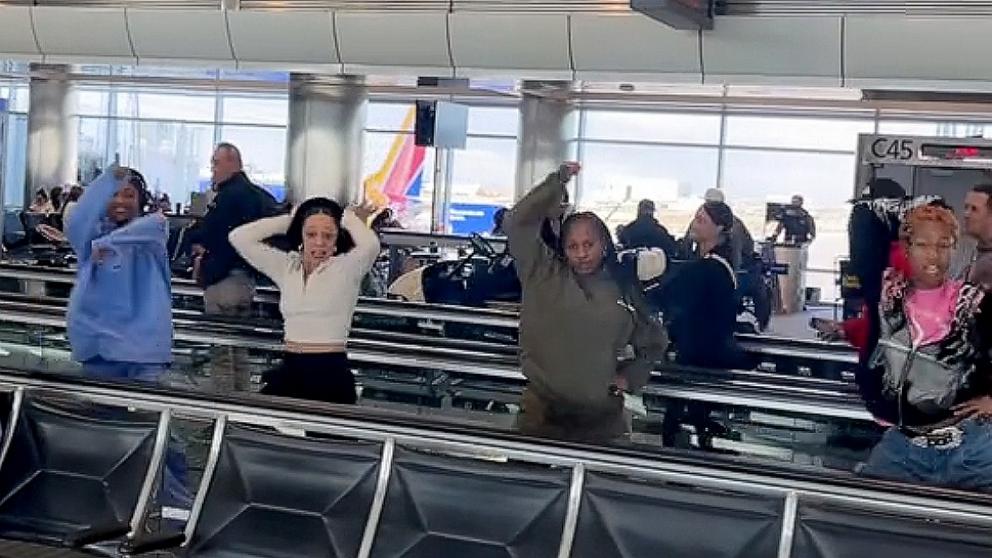 PHOTO: Members of the Hip Hop Nutcracker traveling show dance along a moving walkway at an airport in a viral TikTok video.