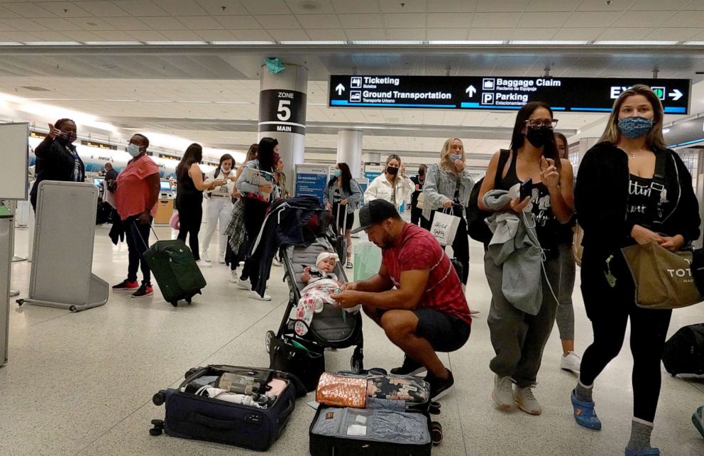 PHOTO: Travelers make their way through the Miami International Airport before starting the Labor Day weekend, Sept. 3, 2021, in Miami.