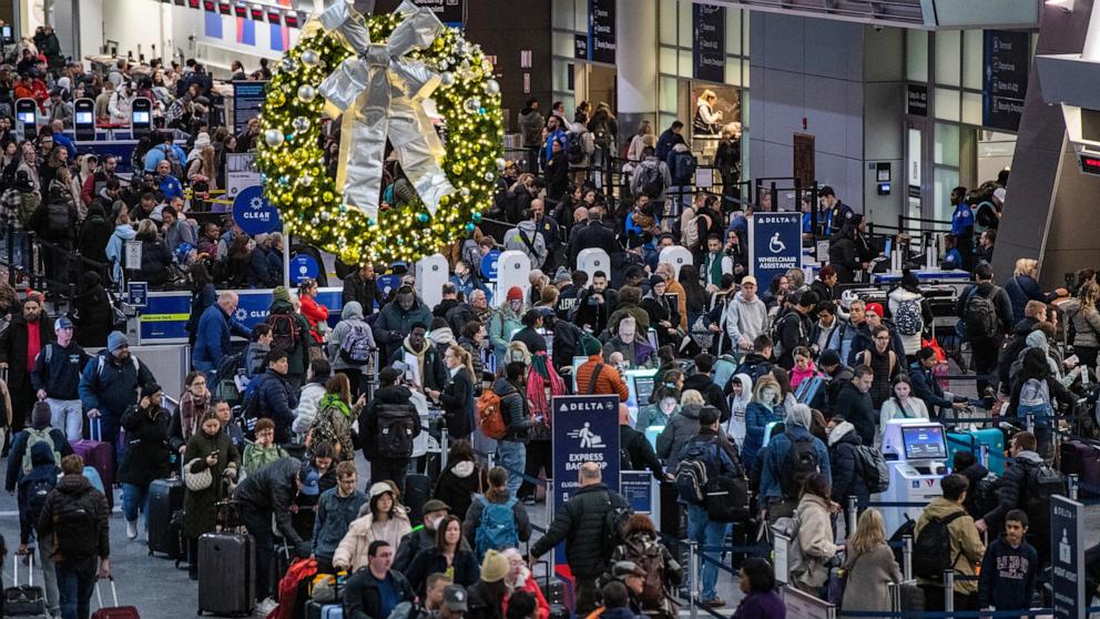 PHOTO: People move through a packed departures level at Terminal A at Boston's Logan Airport, Dec. 23, 2024.