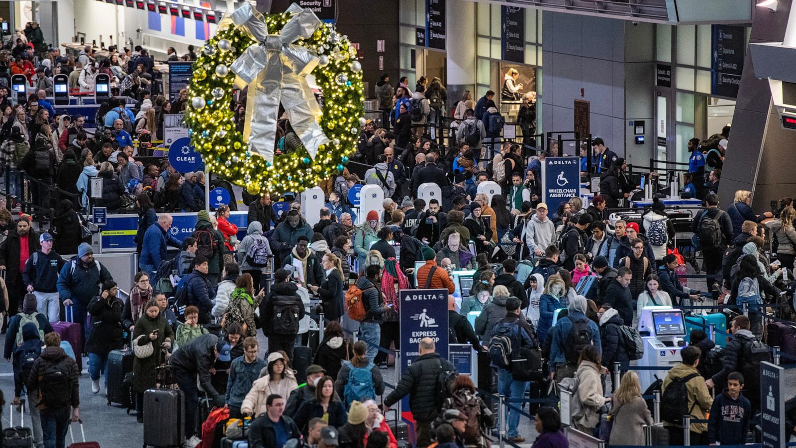 PHOTO: People move through a packed departures level at Terminal A at Boston's Logan Airport, Dec. 23, 2024.