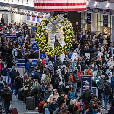 PHOTO: People move through a packed departures level at Terminal A at Boston's Logan Airport, Dec. 23, 2024.