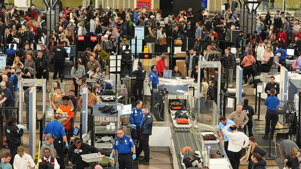 PHOTO: Travelers wade through the south security checkpoint in Denver International Airport, Dec. 19, 2024.