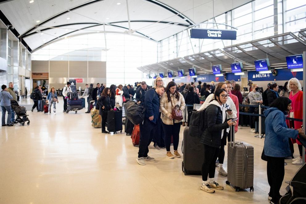 PHOTO: Travelers wait in line for departures at the Detroit Metropolitan Wayne County Airport (DTW) on December 1, 2024 in Romulus, Michigan.