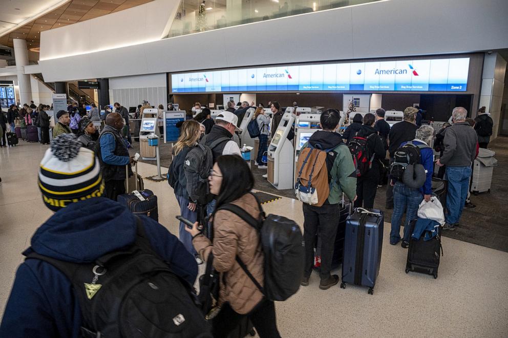 PHOTO: In this Dec. 27, 2022, file photo, travelers wait to check-in at the American Airlines counter at San Francisco International Airport (SFO) in San Francisco.