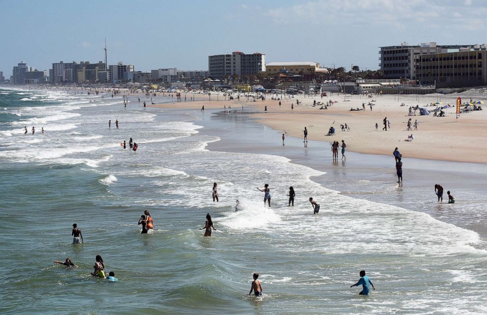 PHOTO: People enjoy the sun and surf at Daytona Beach, Fla., March 20, 2020. 