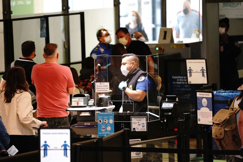 PHOTO: In this May 28, 2021, file photo, travelers go through a Transportation Security Administration (TSA) checkpoint at Los Angeles International Airport (LAX) in Los Angeles.