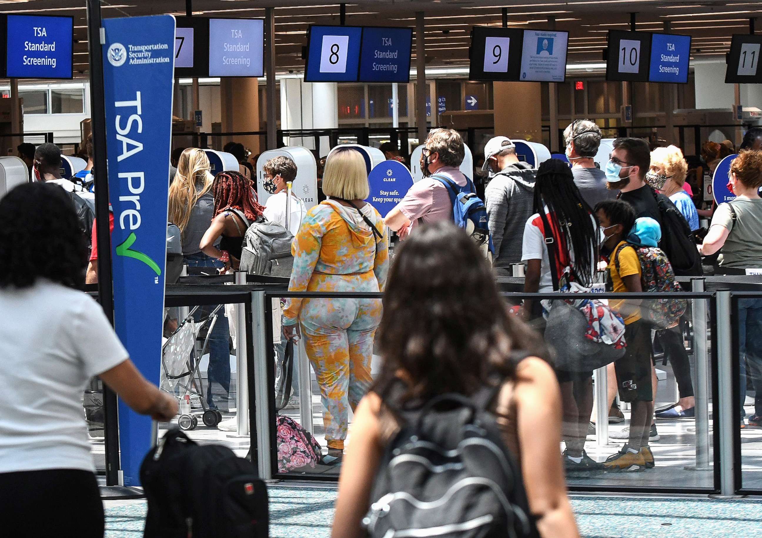PHOTO: In this May 28, 2021, file photo, travelers wait in line at a Transportation Security Administration (TSA) screening checkpoint at Orlando International Airport in Orlando, Fla.