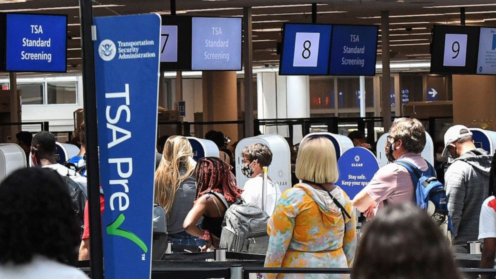PHOTO: In this May 28, 2021, file photo, travelers wait in line at a Transportation Security Administration (TSA) screening checkpoint at Orlando International Airport in Orlando, Fla.