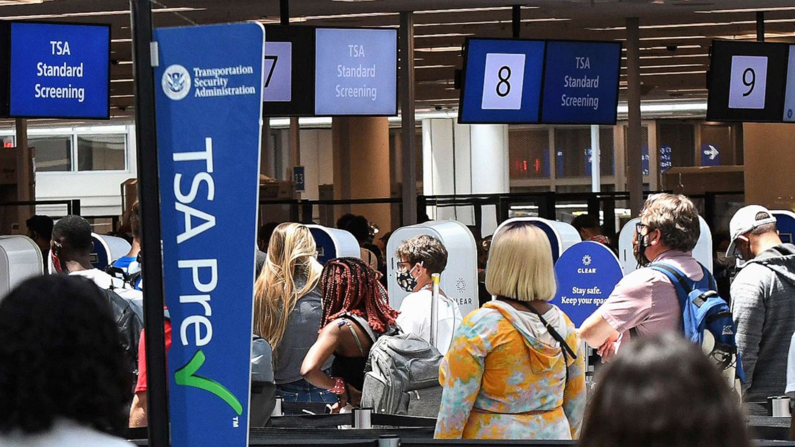 PHOTO: In this May 28, 2021, file photo, travelers wait in line at a Transportation Security Administration (TSA) screening checkpoint at Orlando International Airport in Orlando, Fla.