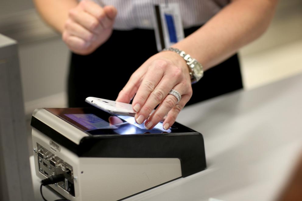 PHOTO: In this March 4, 2015 file photo CBP Demonstrates New App as she uses the new mobile app for expedited passport and customer screening being unveiled for international travelers arriving at Miami International Airport.