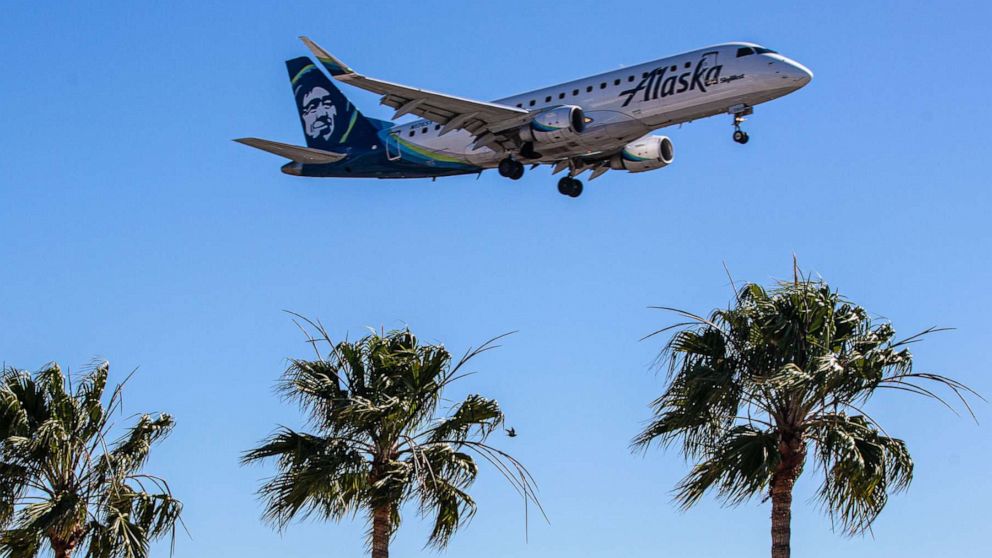 PHOTO: An Alaska airline plane flies near the Los Angeles International Airport on Feb. 7, 2022 in Los Angeles.