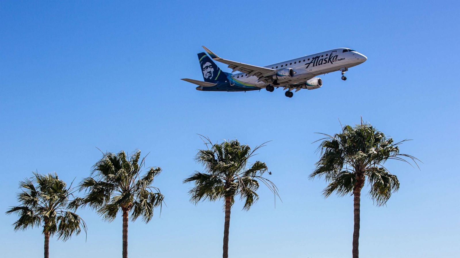 PHOTO: An Alaska airline plane flies near the Los Angeles International Airport on Feb. 7, 2022 in Los Angeles.