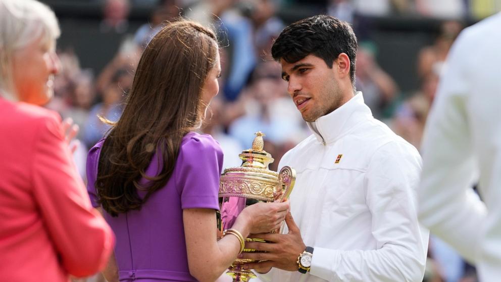 PHOTO: Carlos Alcaraz of Spain receives his trophy from Kate, Princess of Wales after defeating Novak Djokovic of Serbia in the men's singles final at the Wimbledon tennis championships in London, July 14, 2024. 