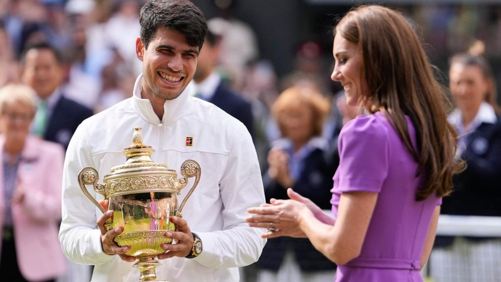 PHOTO: Carlos Alcaraz of Spain reacts after receiving his trophy from Kate, Princess of Wales after defeating Novak Djokovic of Serbia in the men's singles final at the Wimbledon tennis championships in London, July 14, 2024. 