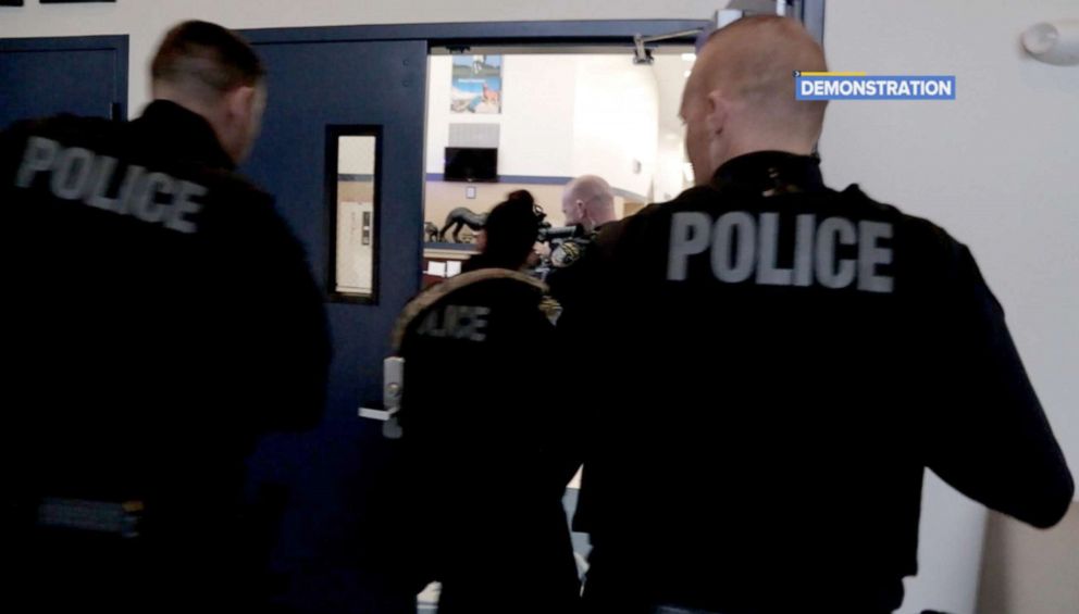 PHOTO: Members of the Coral Springs Police force enter Coral Springs Charter School during a demonstration of the ALERT panic alert system.